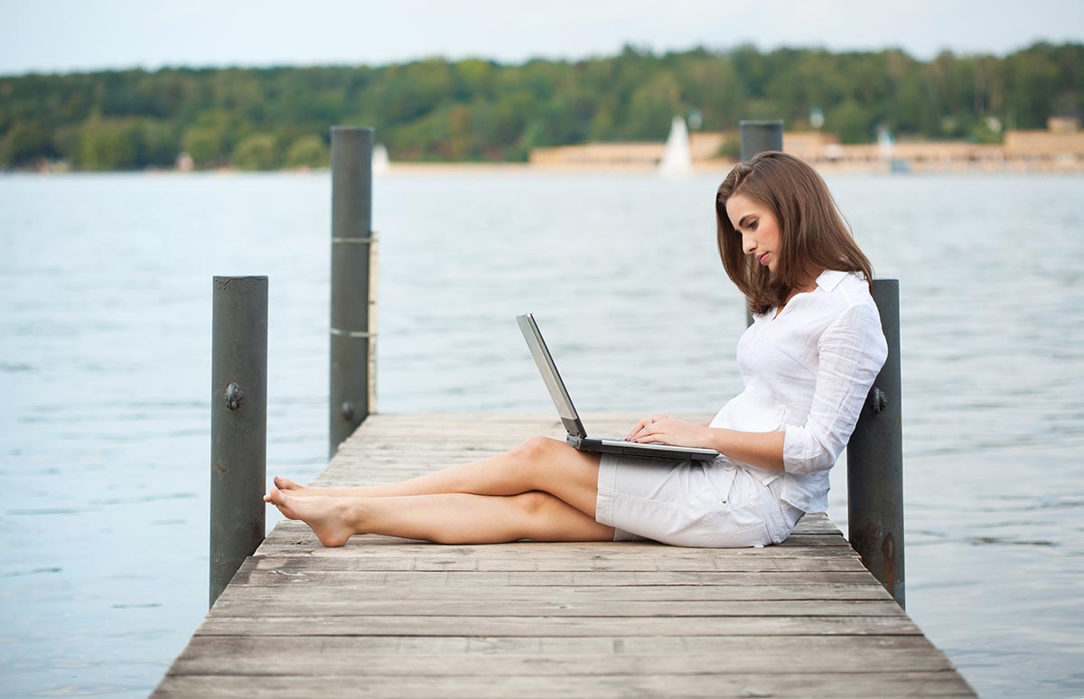 Girl on Dock with Laptop
